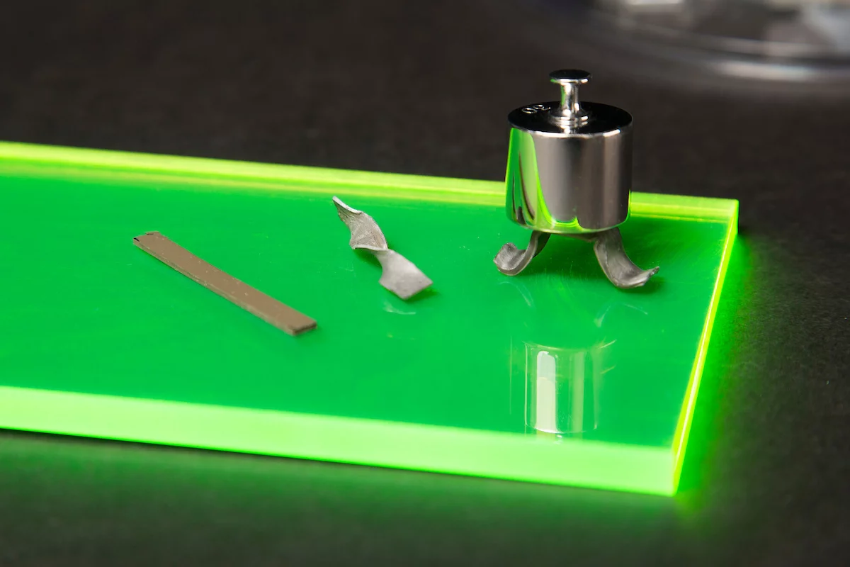 Examples of the new material that turns from rubber to metal under stress: (left) a normal strip of the material, (middle) a twisted strip of the stiffened material holding its new shape, and (right) a demonstration of the strength of the material