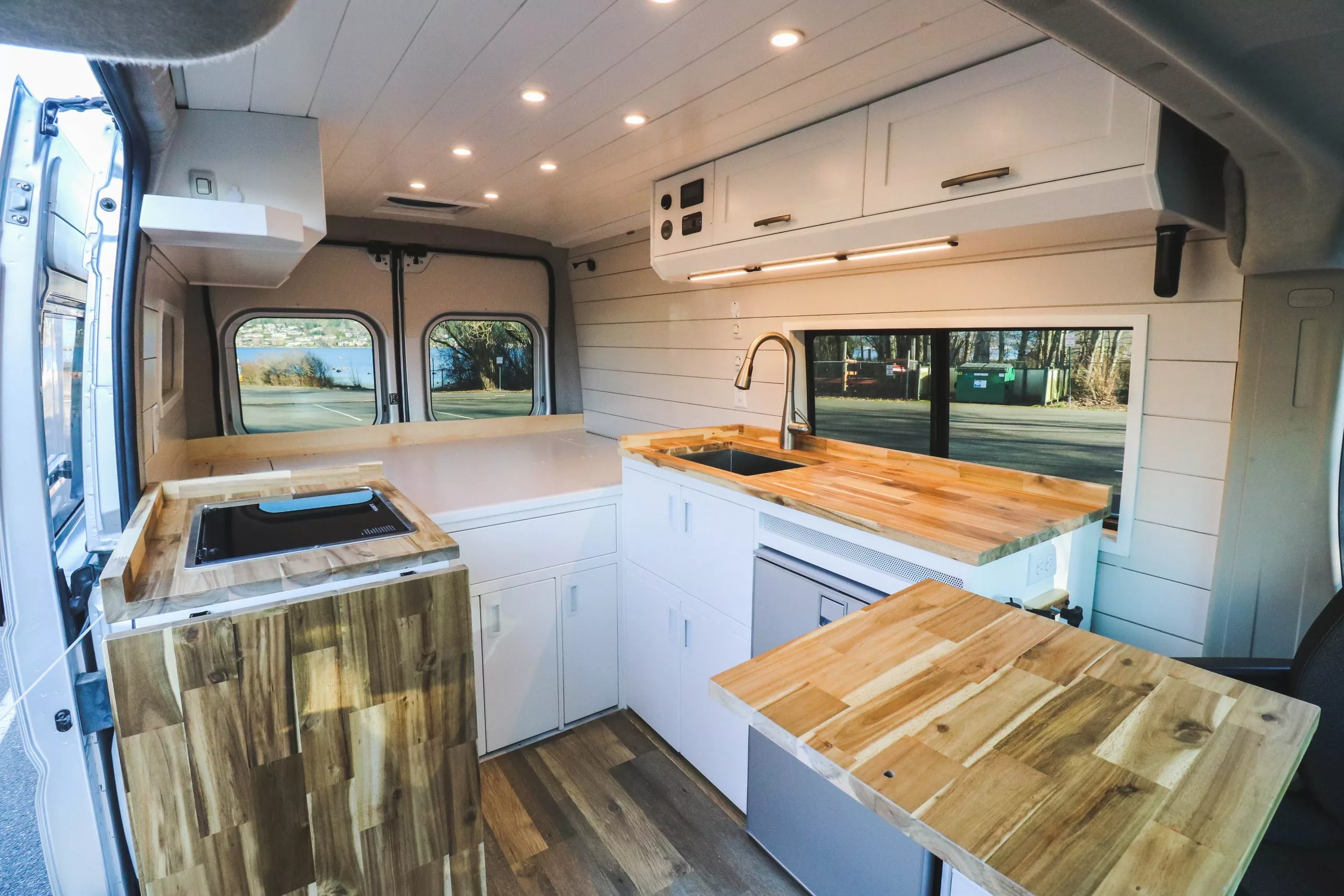 The multi-tone, wood-grain look of the butcher block counters and table warm up the white interior