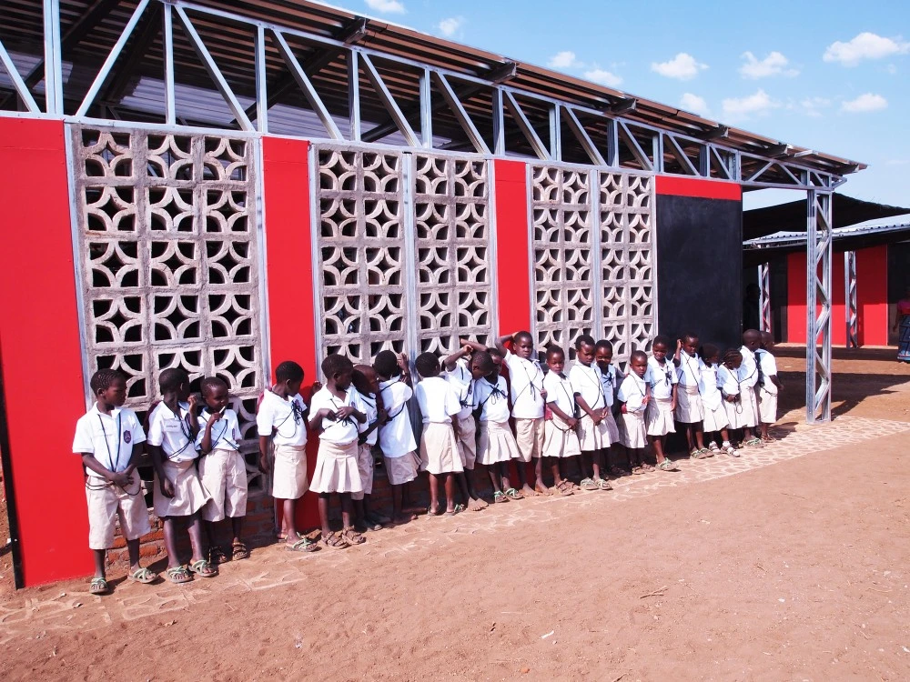 The firm also removed sections of the containers in favor of louver walls made from local masonry to encourage natural ventilation (Photo: Architecture for a change)