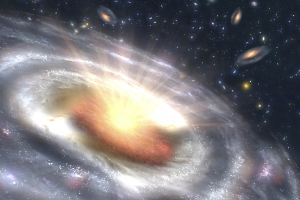 This is an artist's concept of a quasar (bright area with rays) embedded in the center of a galaxy. (Image: NASA/JPL-Caltech/T. Pyle - SSC)