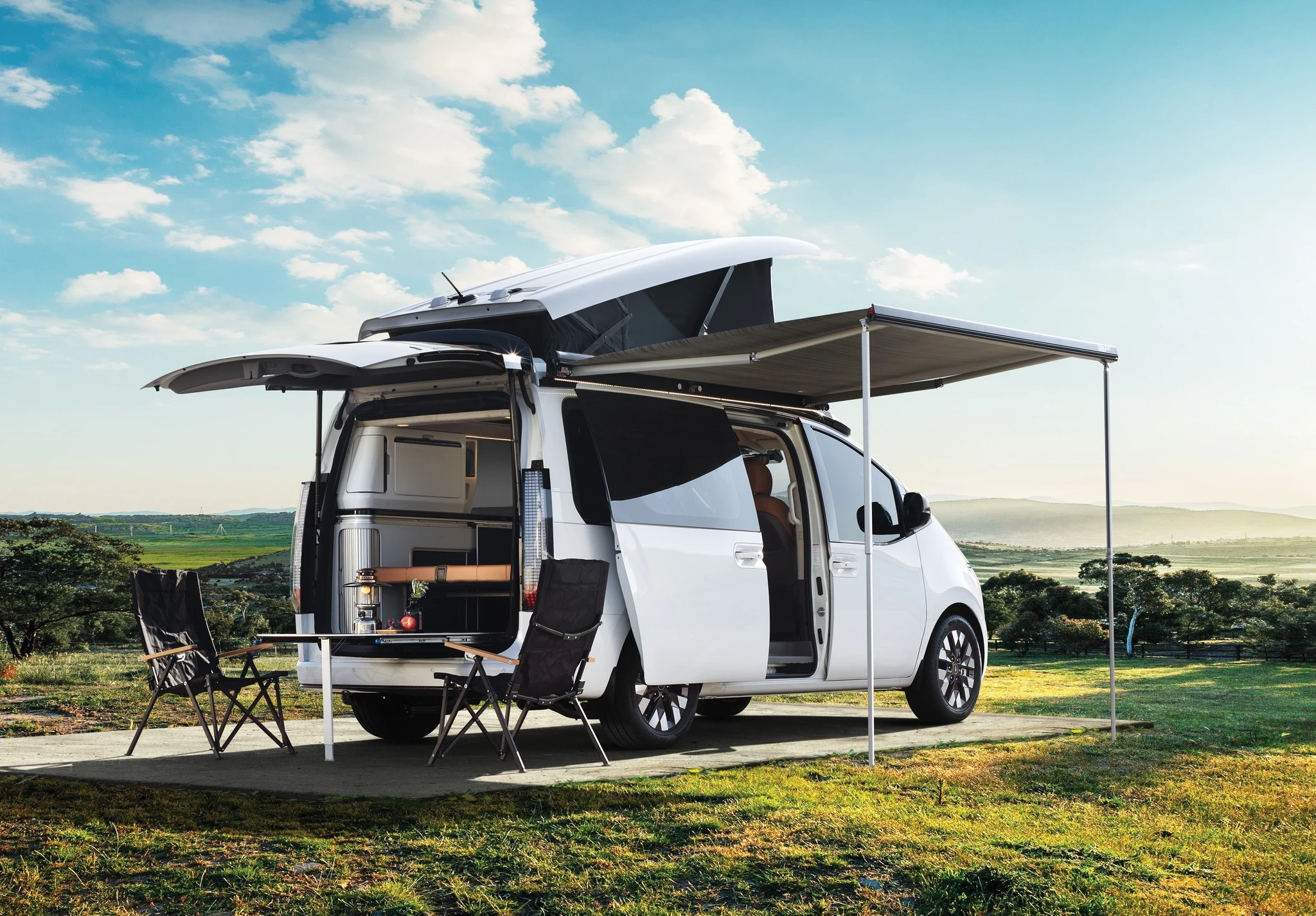 Hyundai's Staria Lounge Camper 4 comes with a full conversion that includes two beds, indoor and outdoor dining space, an indoor kitchen, and a smart home control touchscreen