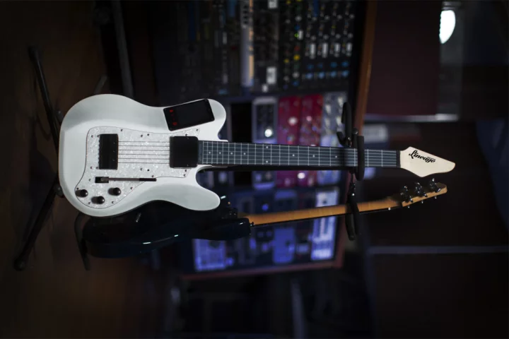 The white model of the Lineage MIDI guitar