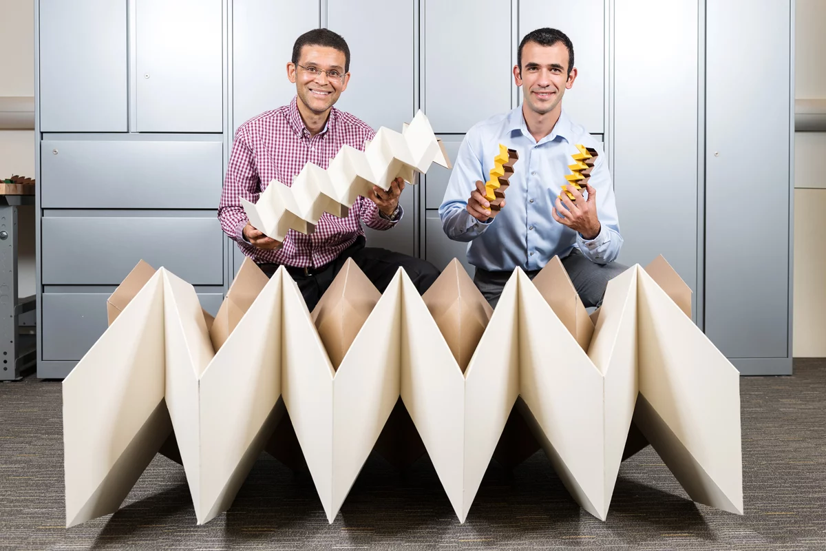 Glaucio Paulino and Evgueni Filipov with the structures resulting from an origami “zippered tube” folding pattern