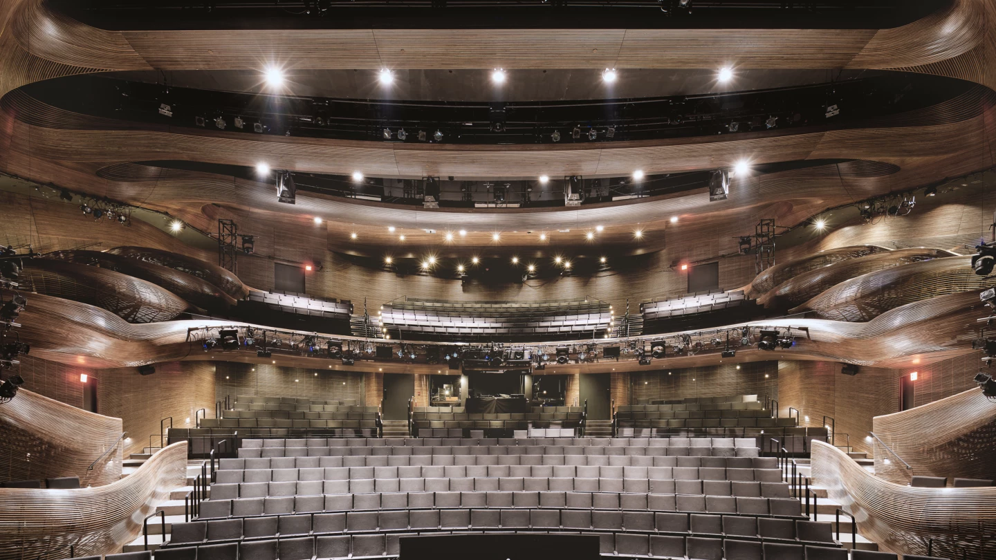Coca-Cola Stage at the Alliance Theatre is defined by beautiful steam-bent wooden railings and balconies. The project is one of this year's winners of the AIA 2021 Interior Architecture Awards