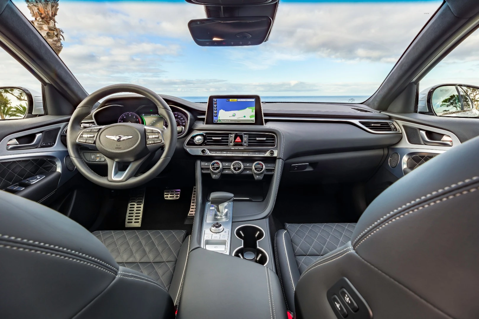 Brushed aluminum surfaces, quilted Nappa leather upholstery, stainless steel speaker grilles, and soft-touch surfaces are found throughout the Genesis G70's interior