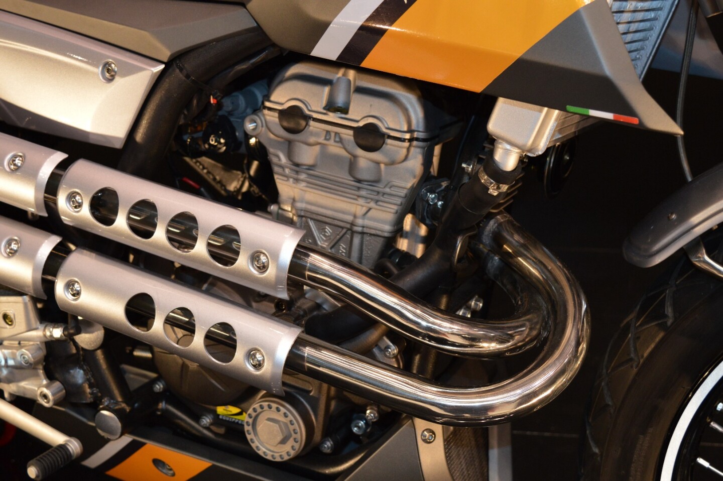 The sculpted Piaggio logo at the base of the cylinder gives away the engine's pedigree