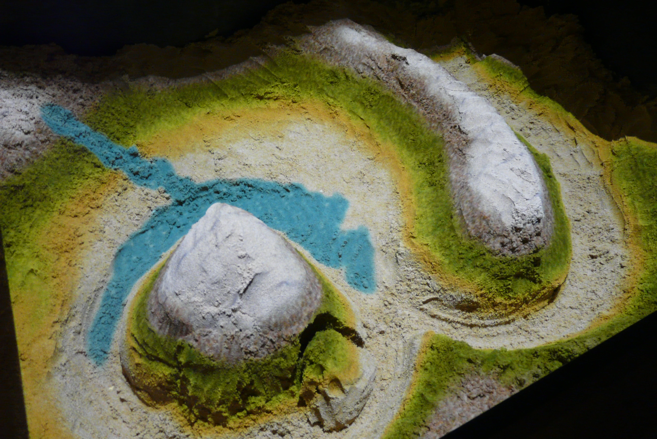 A person can carve out rivers with the SandyStation using the Xbox Kinect.
