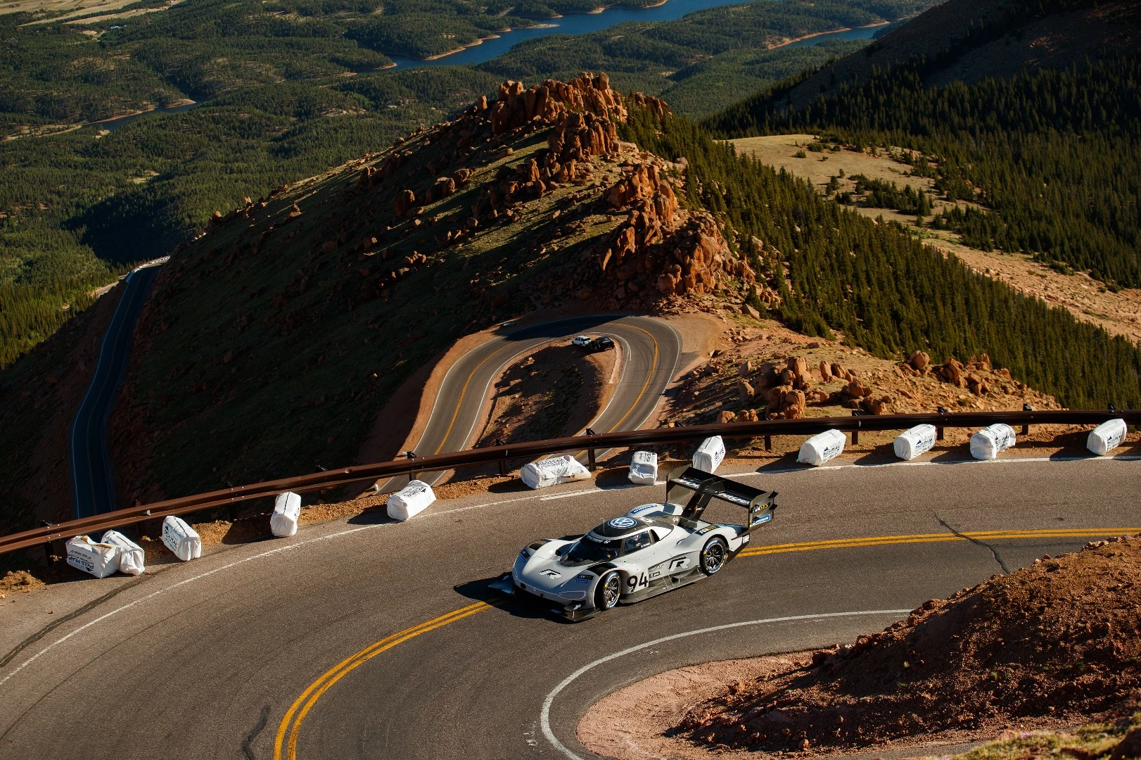 Romain Dumas and the Volkswagen I.D. R race car working their way up Pikes Peak fast enough to take the win and the all-time record