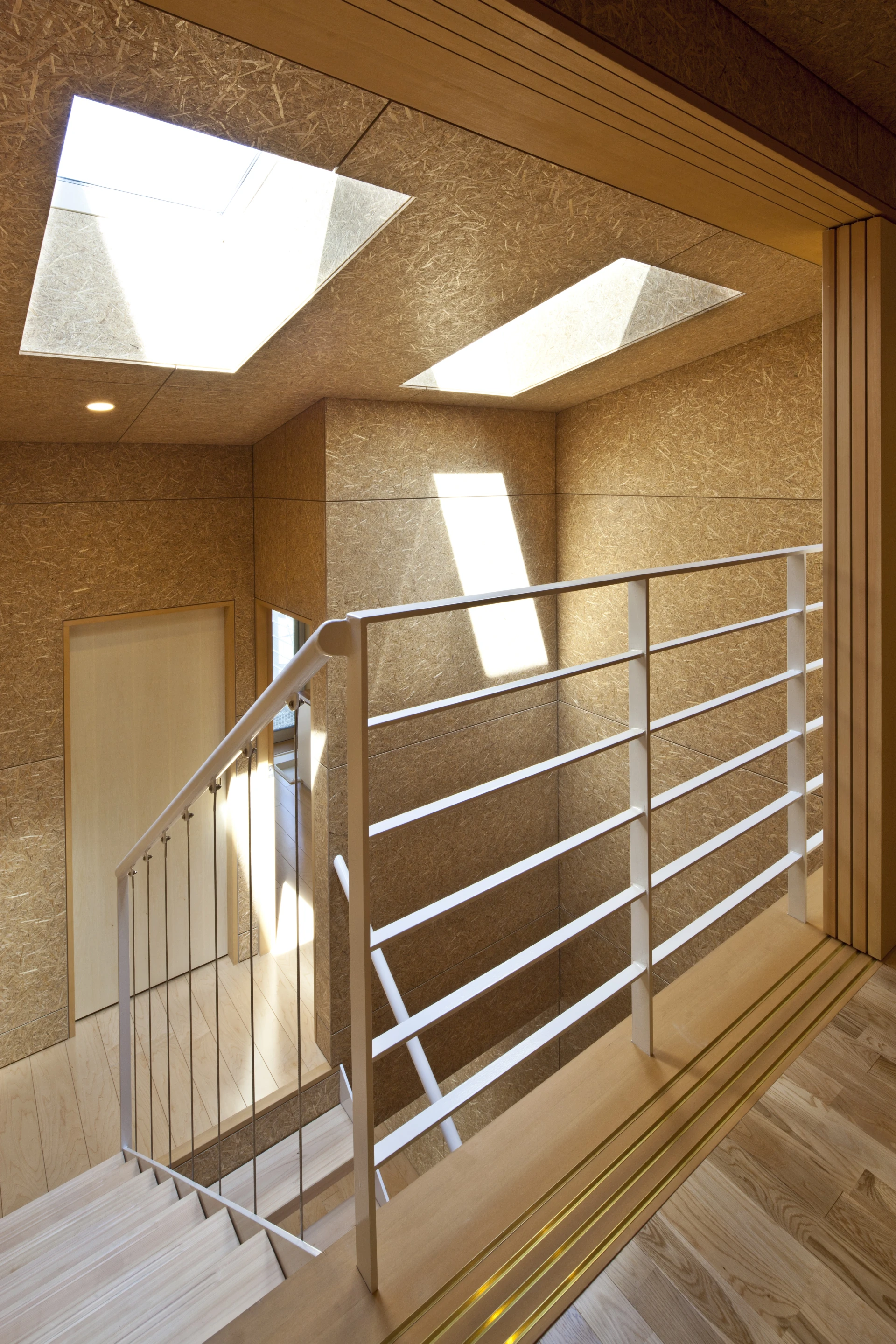 A central atrium acts as a focal point for family members and benefits from skylights to brighten the area below (Photo: Stirling Elmendorf)