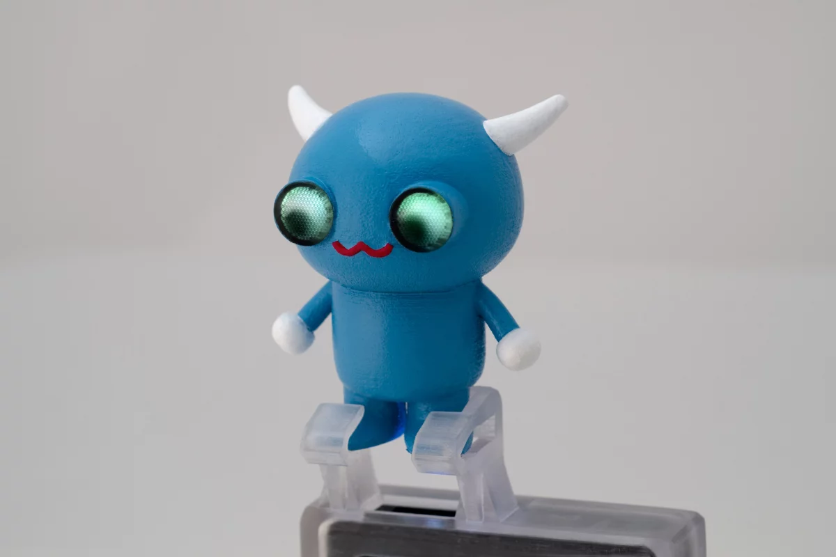 A 3D printed mobile projector accessory with embedded light pipes that direct light to the character's eyes