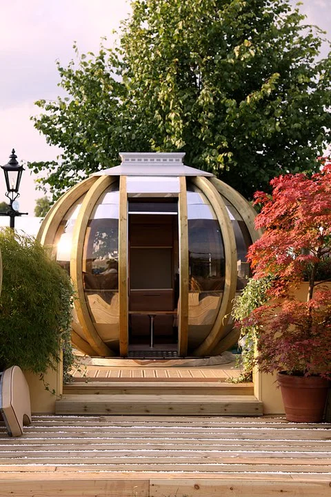 Summerhouse is 10 feet in diameter and features a curved wooden frame, stainless steel roof and tinted UV protected polycarbonate windows