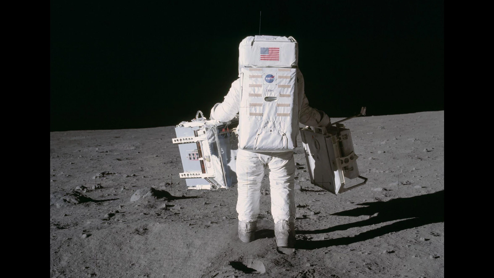 Buzz Aldrin pictured during the Apollo 11 mission carrying a Laser Ranging Retro-Reflector in his right hand