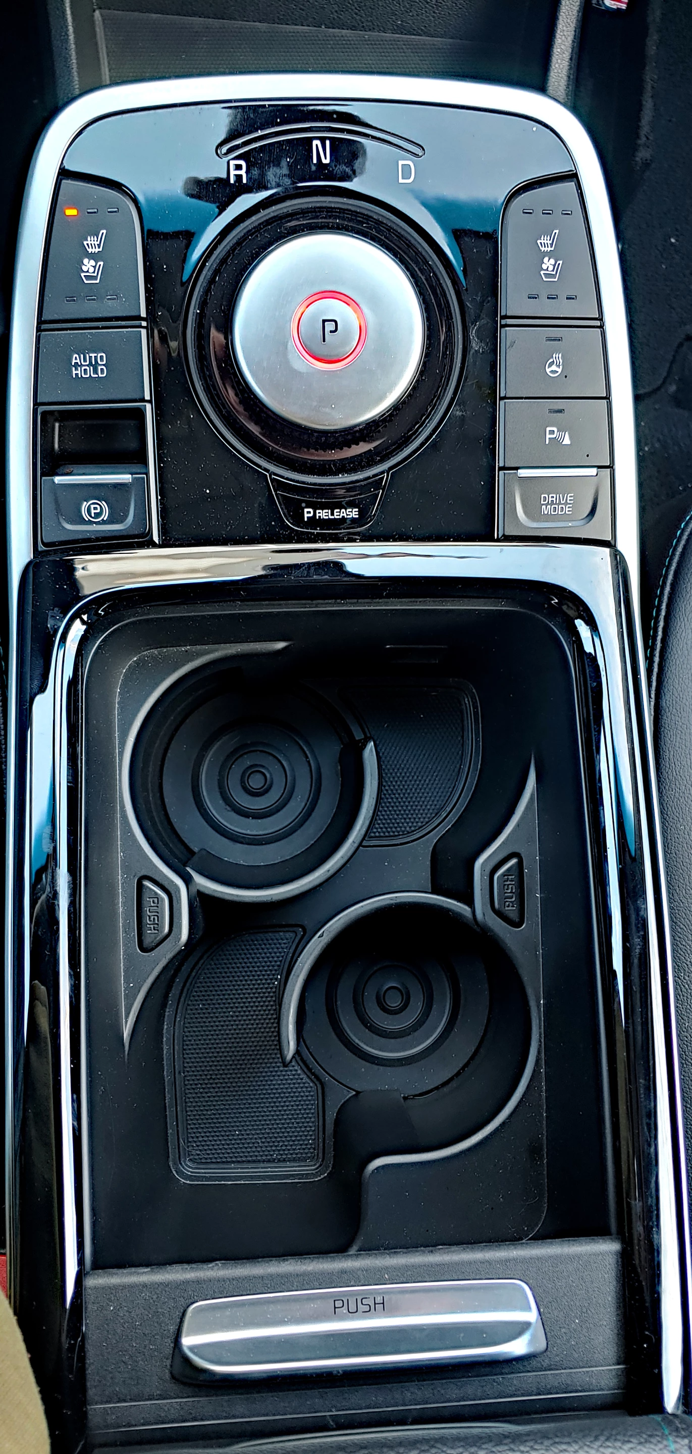 The center console of the Niro EV has a shifter (top) and innovative drink holders that can be "opened" to create a large storage bin instead