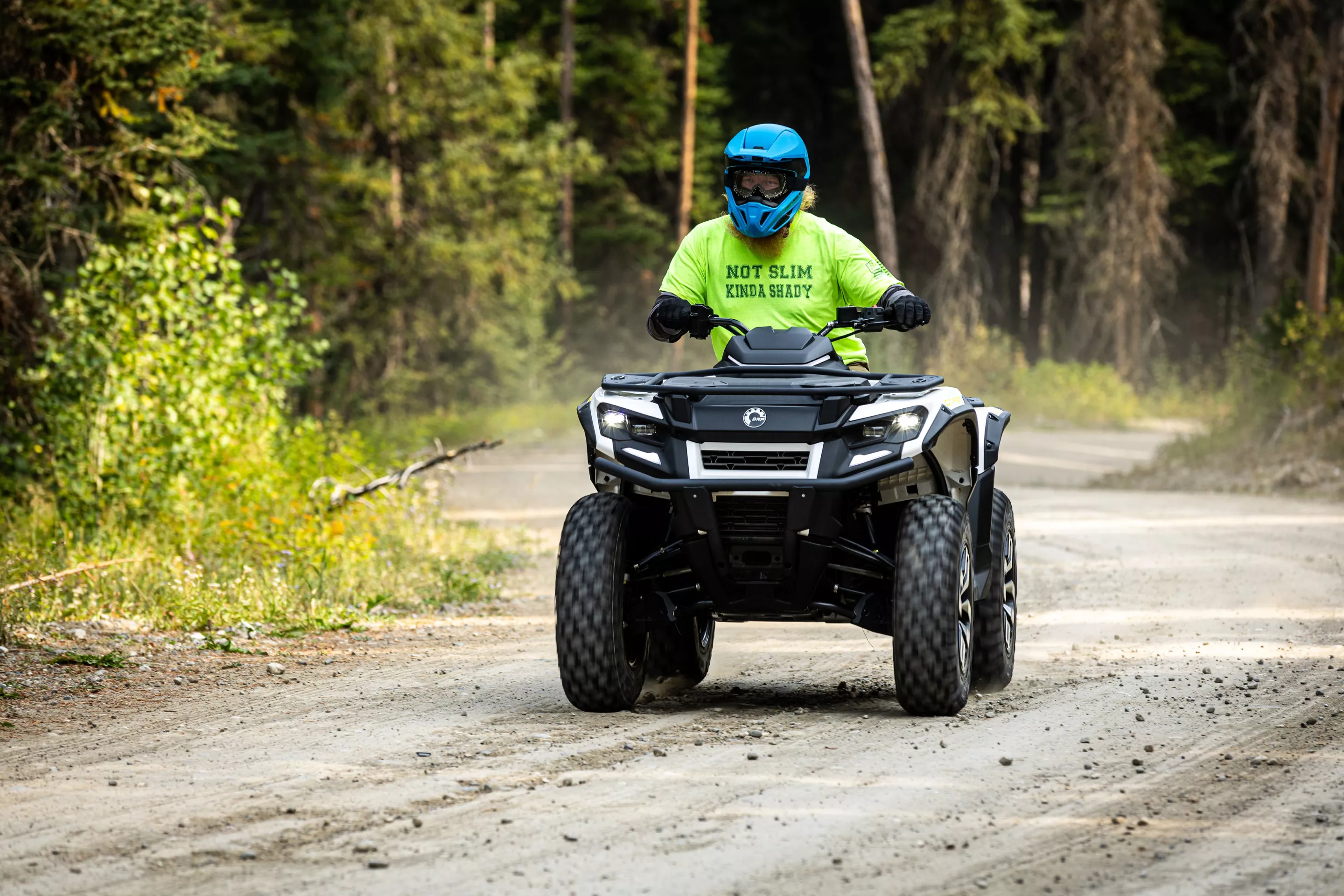 The author rides along a dirt road towards a trail atop a 2026 Can-Am Outlander Electric in Wyoming