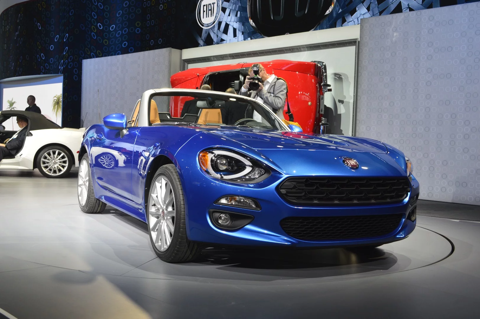 Big, round, three-light portals sit at the corners of this little roadster