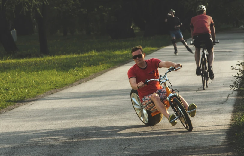 The rider's feet rest on pegs attached to the front axle, and it cannot be pedaled