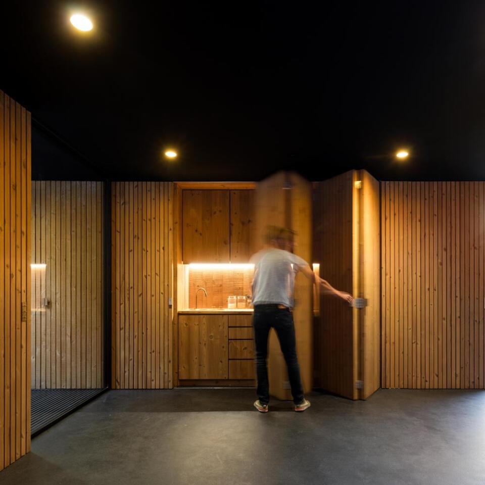 The walls hide the home's compact wall-kitchen