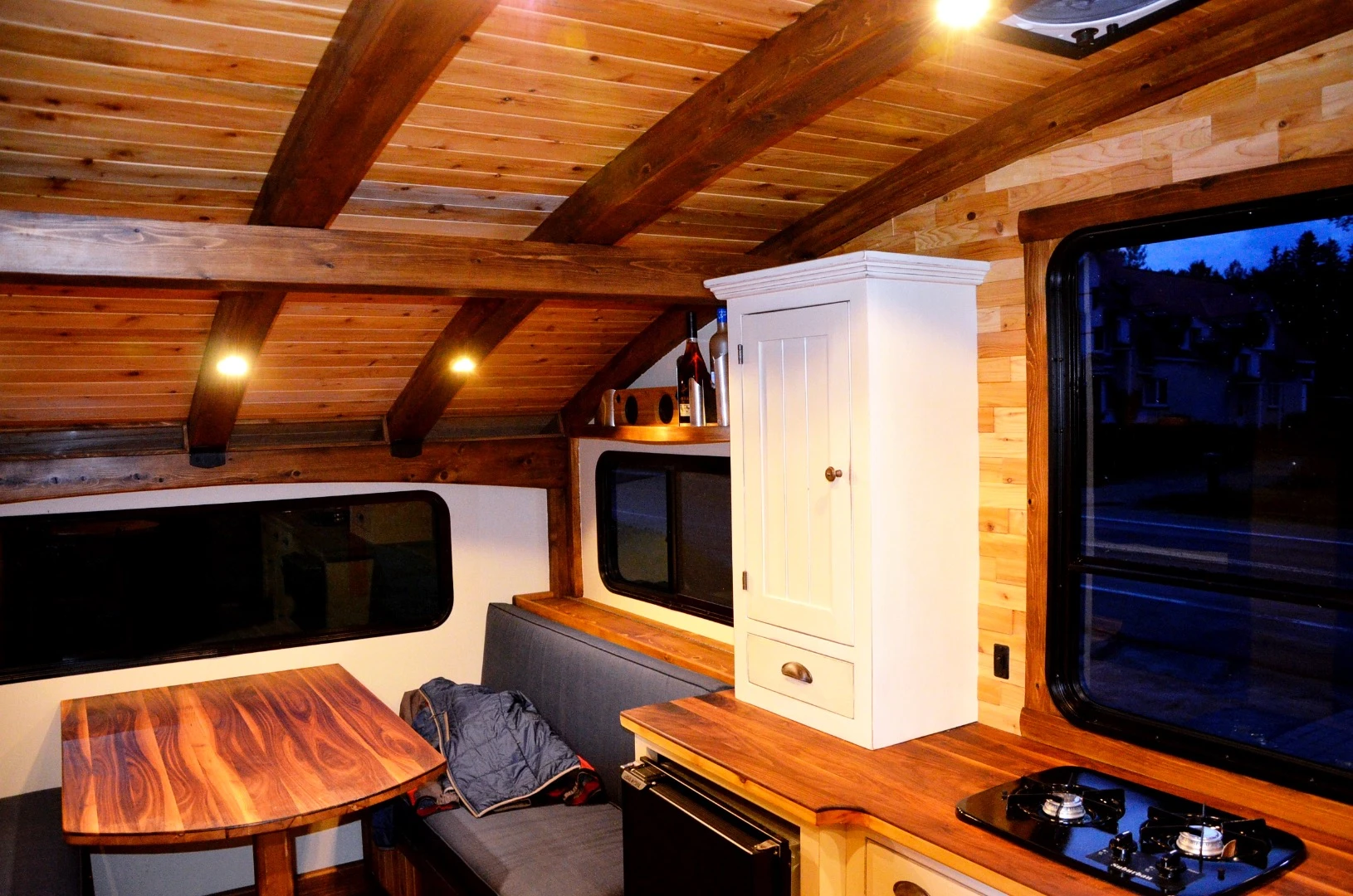 Le Koroc's kitchenette includes a two-burner stove, sink, fridge, and storage space