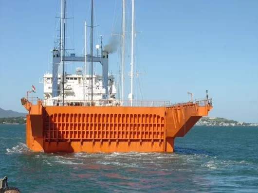 The yacht express leaves port, transporting yachts to new destinations