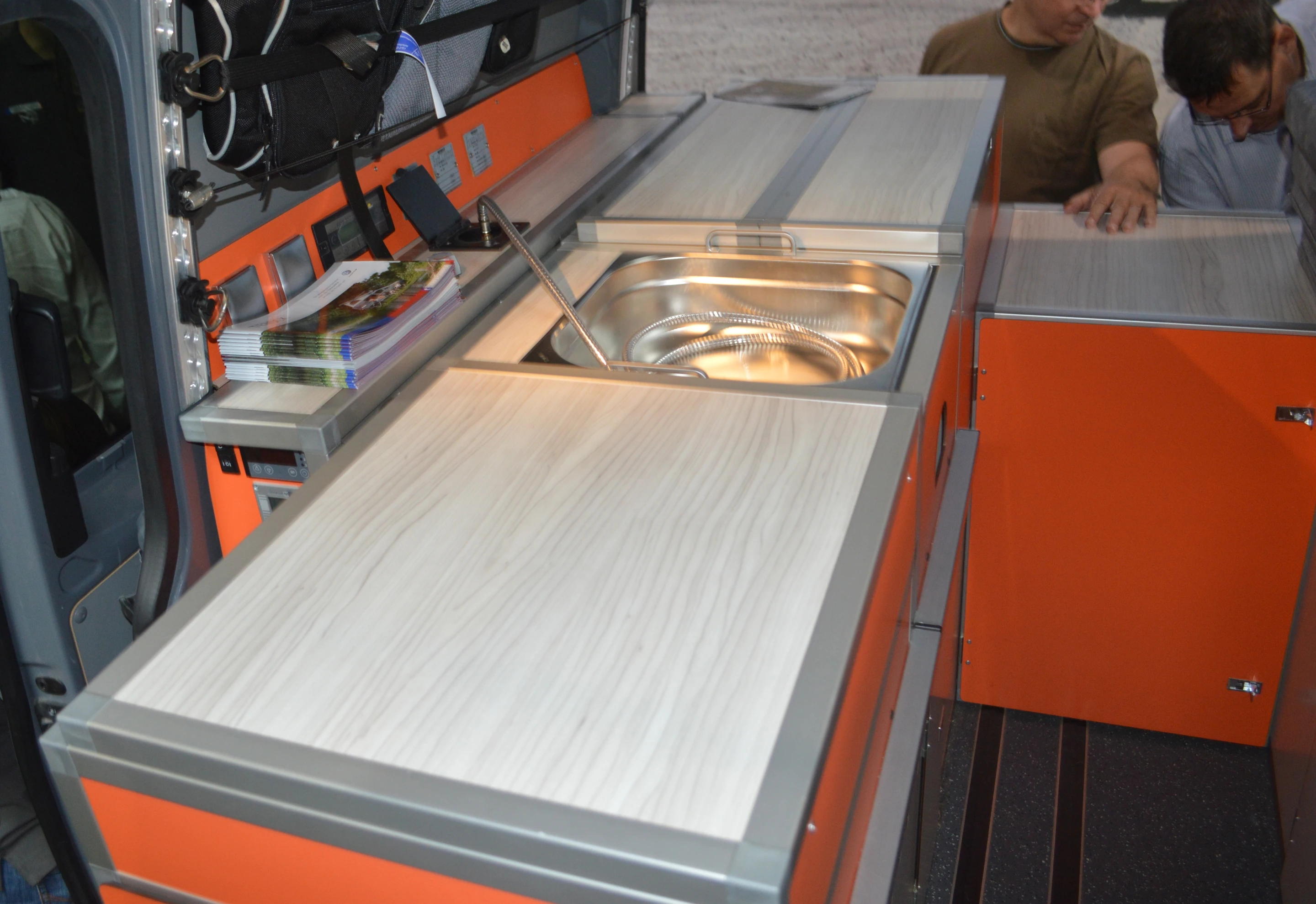 The aluminum camper boxes slide into rails in the van floor