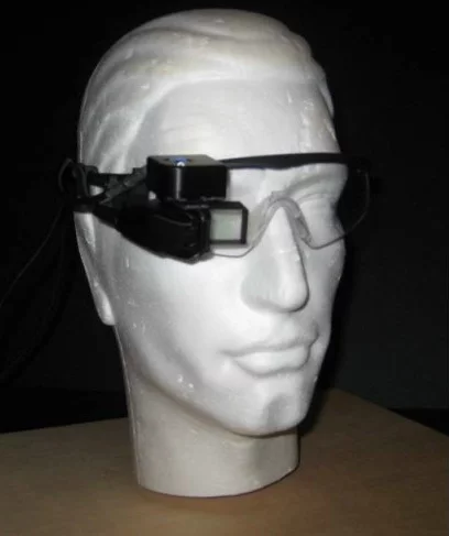 While wearing the glasses, a pilot can see a 3D virtual overlay of the runway and airport in one eye