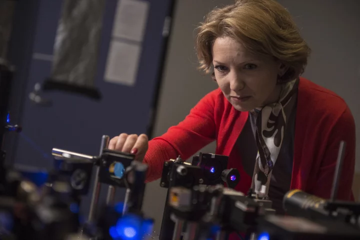 Rice University research scientist Ekaterina Lukianova-Hleb adjusts equipment used in experimentation on plasmonic nanobubbles. (Credit: Jeff Fitlow/Rice University)