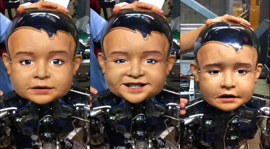 Diego-san, an expressive infant robot developed for UCSD's Machine Perception Lab, makes faces for the camera