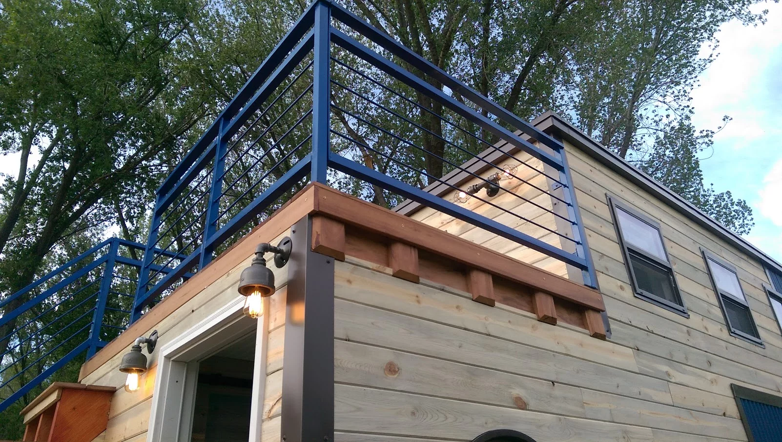 The Tiny Ski Lodge has an upper deck area that's accessed by stairs