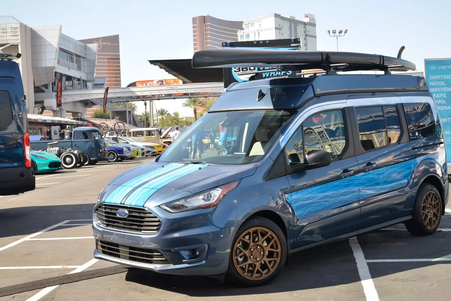 This surfy, pop-top Ford Transit Connect camper van was built by Ursa Minor, which also specializes in Jeep Wrangler pop-tops