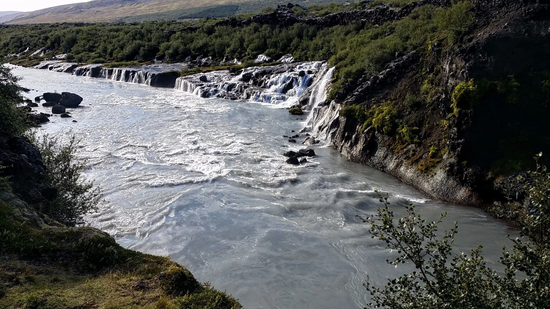 Speaking of porous volcanic rock, this image shows Hraunfossar waterfall, whose name comes from the Icelandic word for lava ("hraun"). The water here literally pours from the side of a riverbank as it flows from lava tubes created when one of the volcanoes lying under the glacier Langjökull erupted around 800 CE.