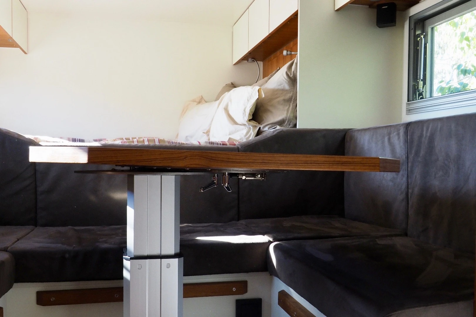 The pedestal table lowers down to form a second bed