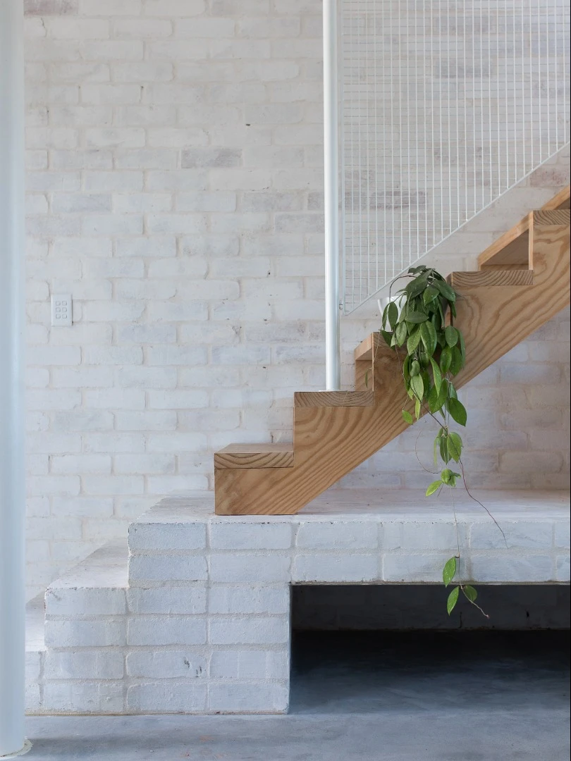 Minimalistic staircase leads to the master bedroom