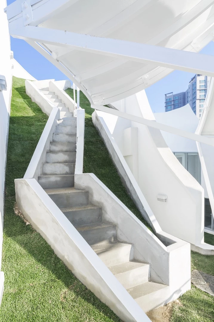 Steps lead up to the Flying House's rooftop area