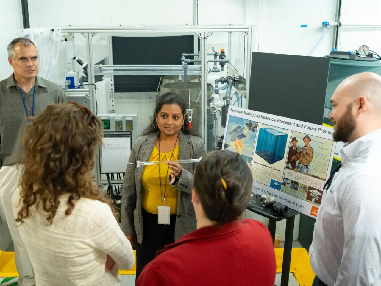 Chemist Chinmayee Subban holds a PNNL device that can extract magnesium oxide from seawater