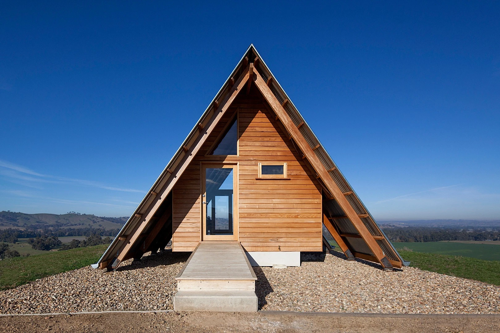 Inside the solar-powered JR's Hut is a bed for two, bathroom with a view and freestanding wood burner fireplace