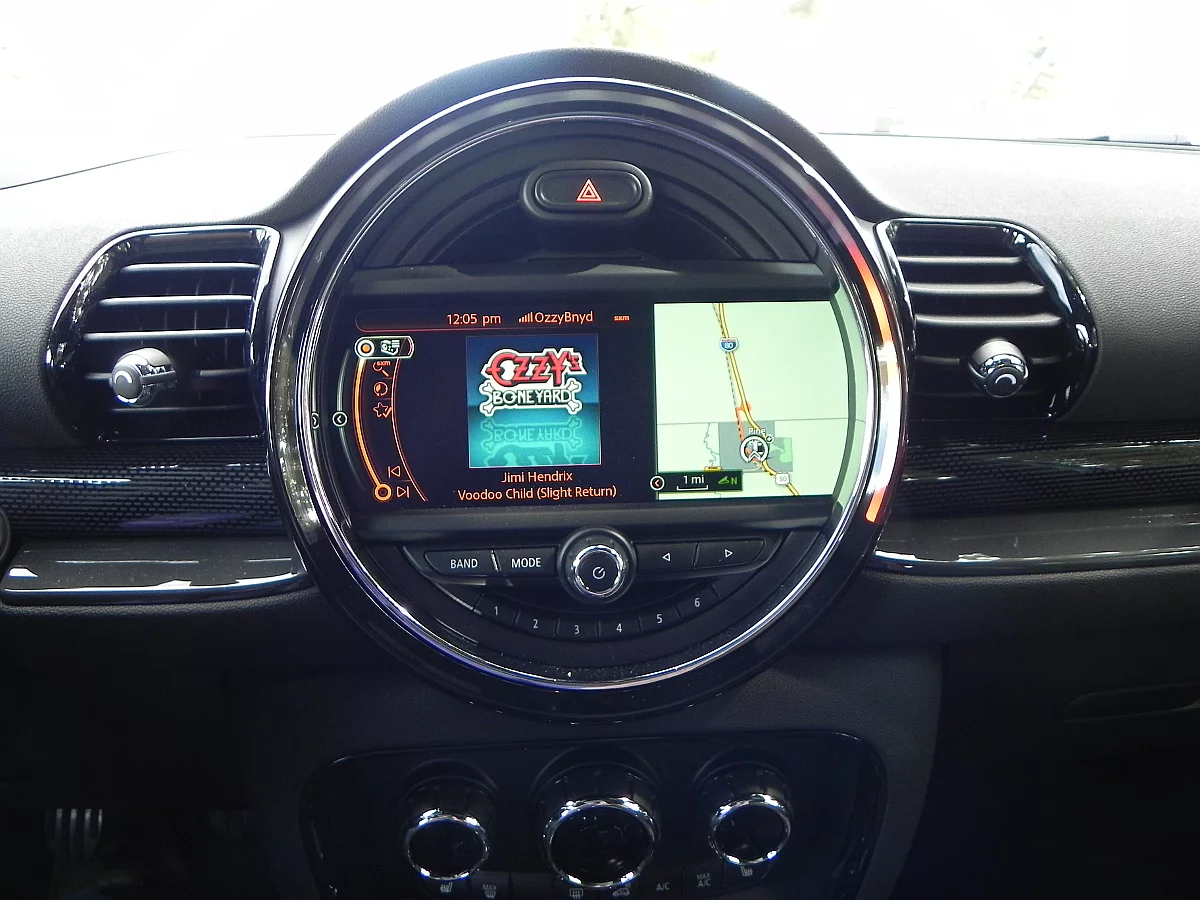 The large round bezel housing the infotainment screen dominates the center of the dashboard