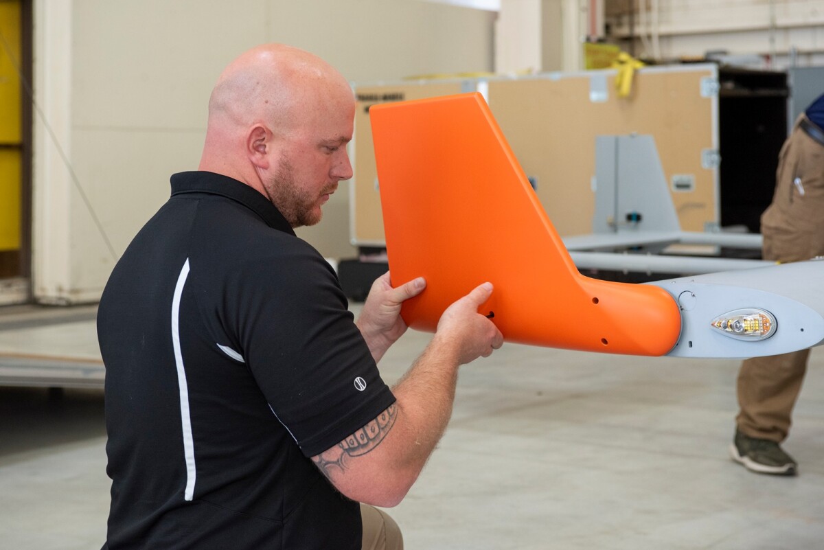 Brad Petty from Navmar Applied Sciences Corporation attaches a winglet to the TigerShark upon arrival at NASA Armstrong Flight Research Center
