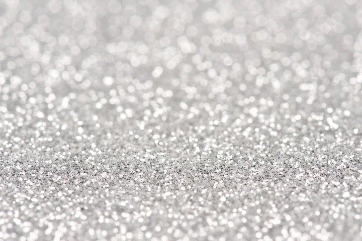 The silver particles are so small in the film that they don't interfere with light passing through them