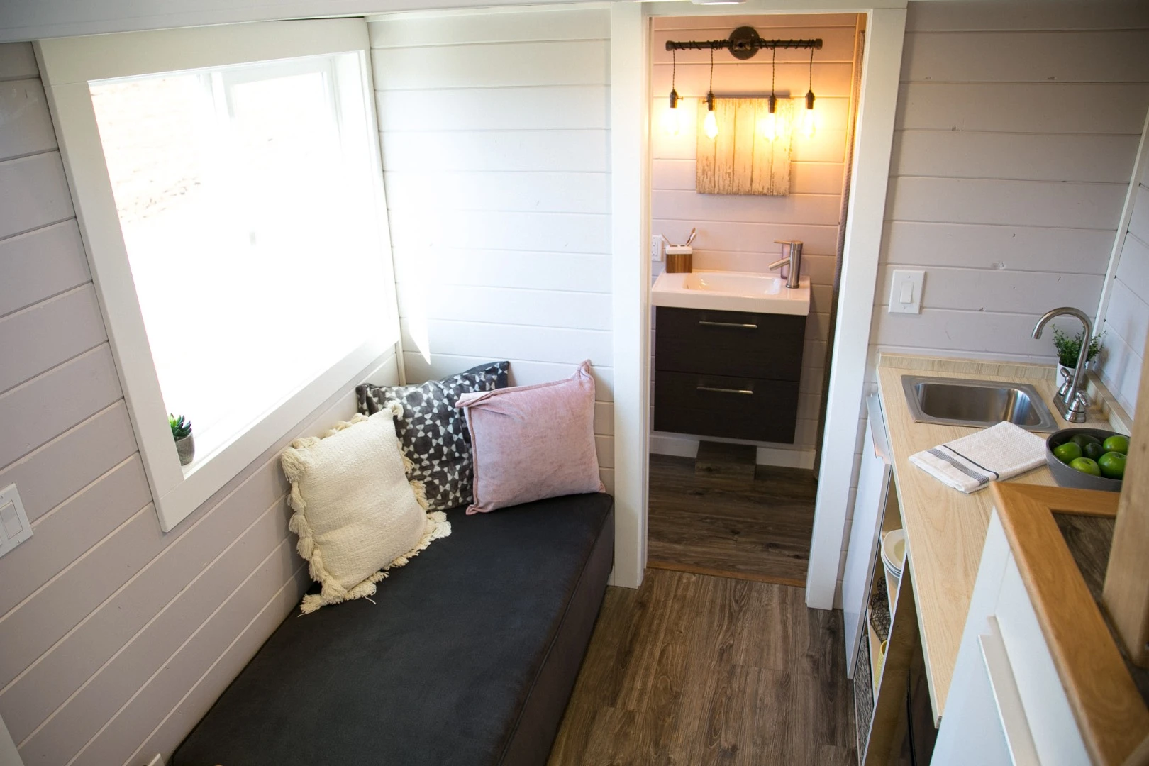 The Kentucky Donut Shop's living room is located next to the bathroom, pictured