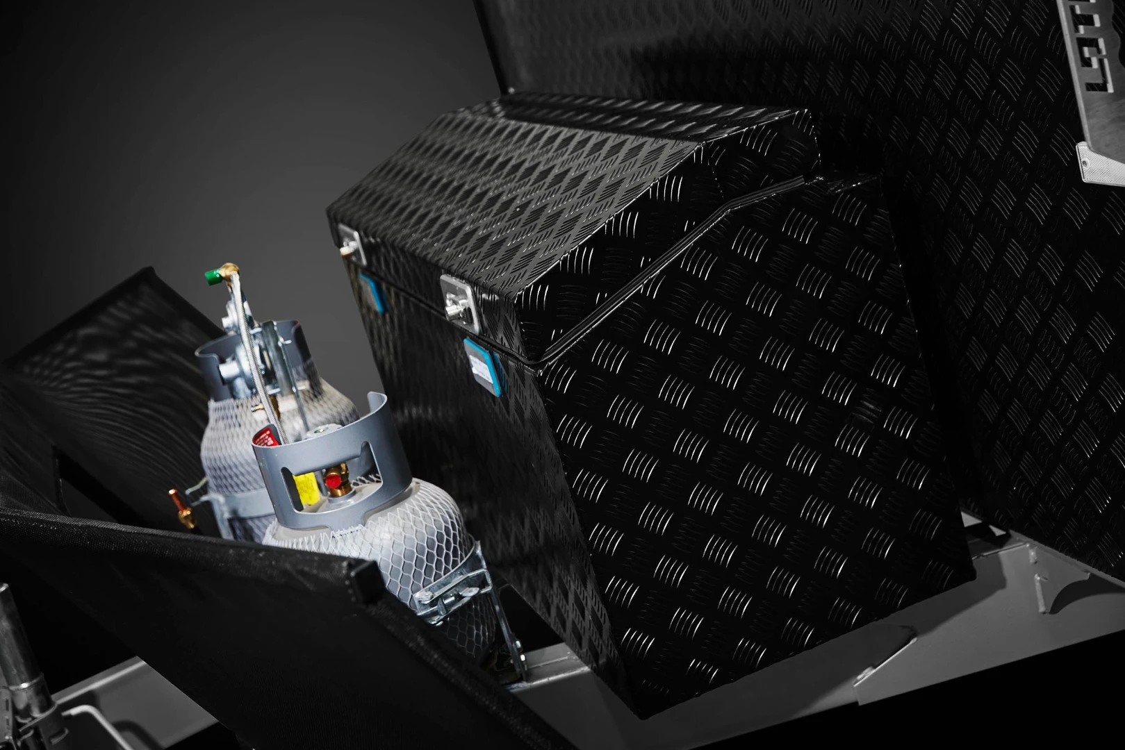 The front includes a stone guard and checker-plate toolbox