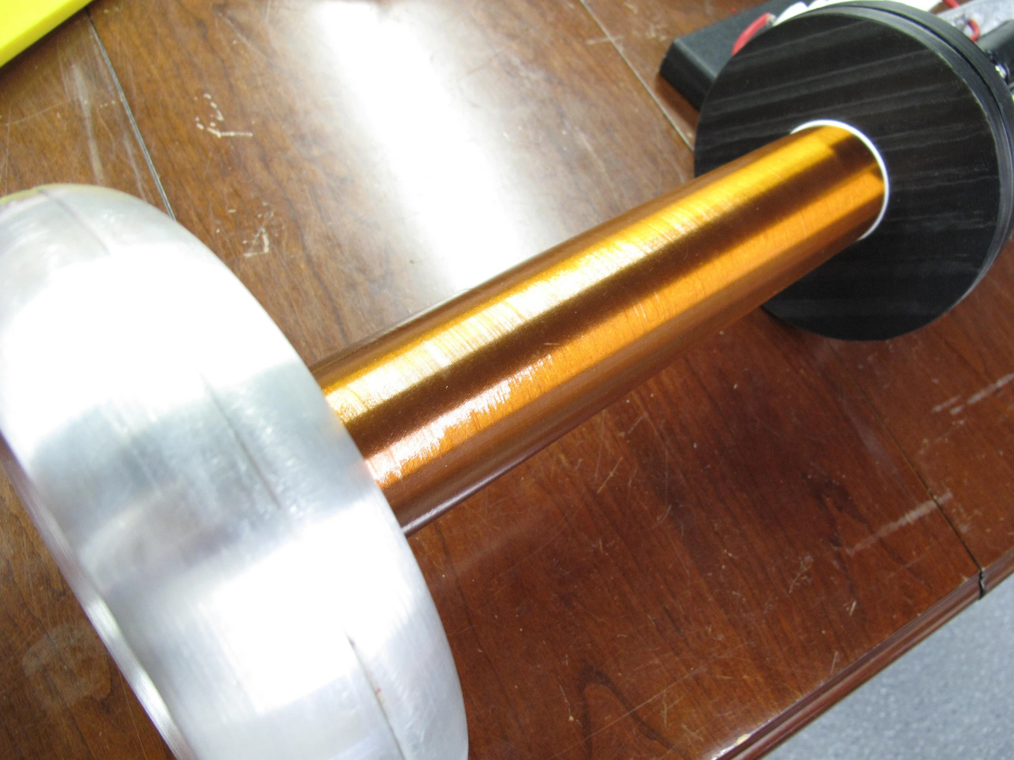 The Tesla Gun's primary and secondary coil, topped by a doughnut-shaped aluminum toroid