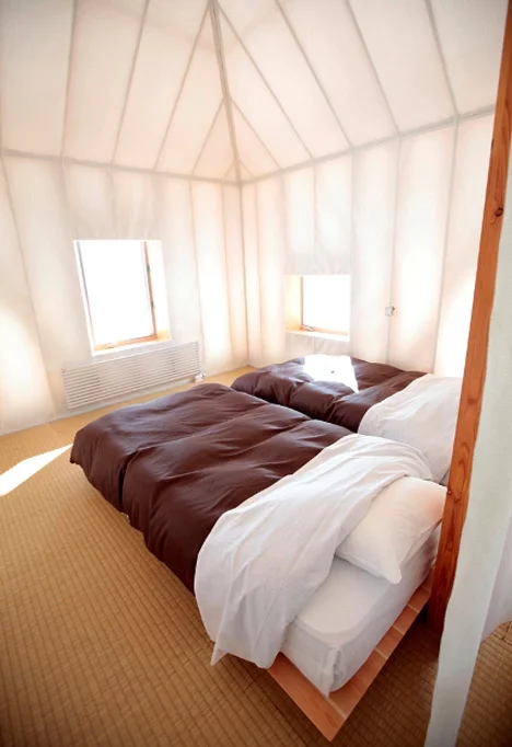 The semi-transparent facade material permits natural indoor lighting throughout the year