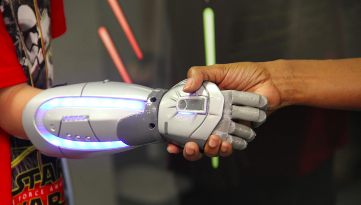 12-yr old Logan demonstrates his new Open Bionics prosthetic hand, styled after art from Star Wars, and complete with LED lighting effects