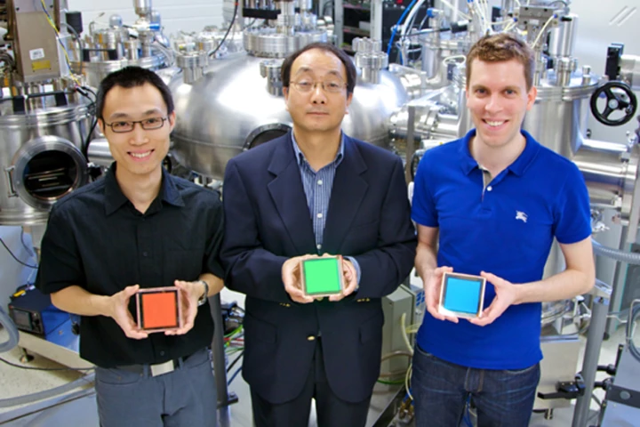 L to R: Zhibin Wang (PhD Candidate), Professor Zheng-Hong Lu, and Michael Helander (PhD Candidate Vanier Canada Graduate Scholar) hold their Cl-ITO enabled OLED devices