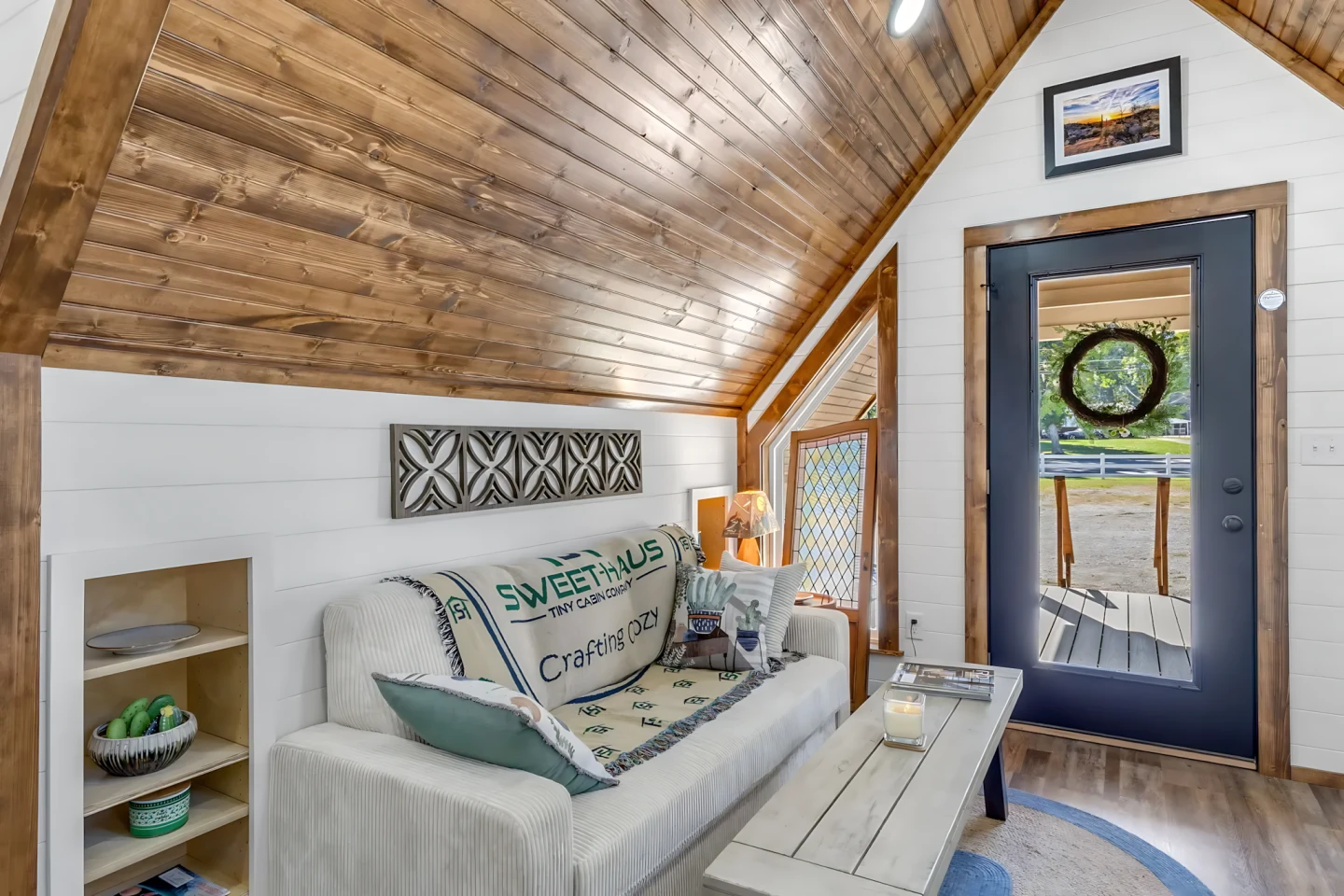 The Tinde's living room includes a sofa, a coffee table, and an armchair