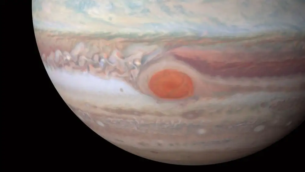Juno is set to swoop low over Jupiter's Great Red Spot, a massive storm that's been raging for centuries, to probe its mysteries