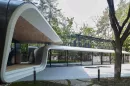 A forest-set garage transforms car storage into a gallery-like architectural space