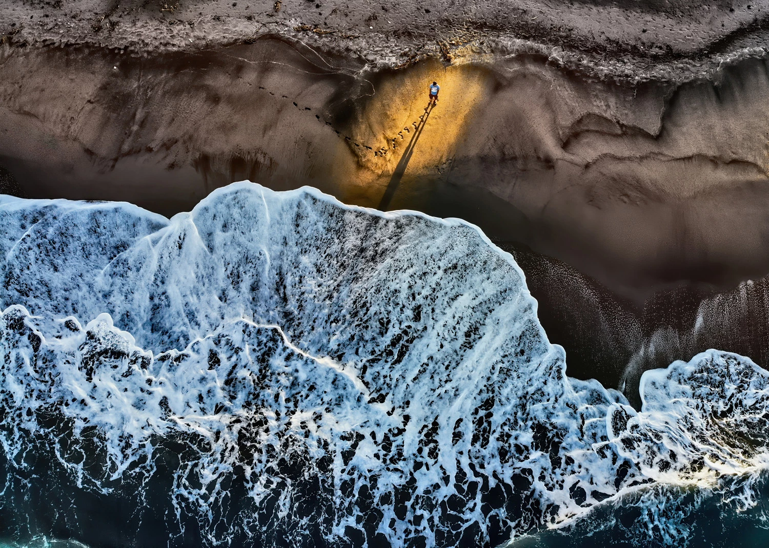 ONE SHOT – SOLITUDEWINNER: Mark Anthony Agtay, PhilippinesBotolan, Zambales, PhilippinesWe were relaxing and observing the tide when the sunrise lit up the shore in a beautiful way.DJI FC2103, f2.8, 1/240 sec, ISO 100