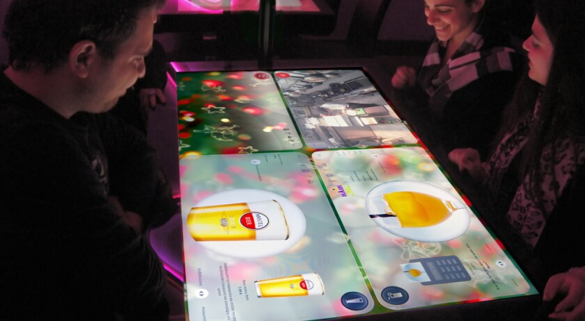 While they're waiting for their food to arrive, patrons can use the table to do things like play games, read news, or chat with diners at other tables