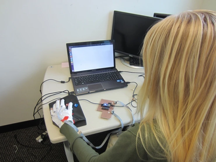 The wearable computing glove delivers vibrations to the wearer's knuckles that correspond with the typing sequence of a phrase in Braille
